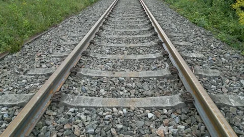 Upwards tilting camera drone video over railway revealing rails in the dista Stock Footage 249266721