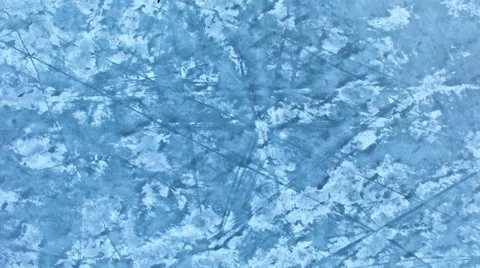 Upwards tilting shot shot of the surface of a frozen lake during sunset Stock Footage 63157487