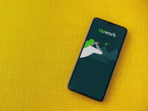 Upwork app launch screen with logo on the display of a black mobile smartphon Stock Photos