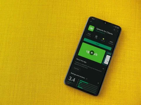Upwork for Clients app play store page on the display of a black mobile smart Foto stock