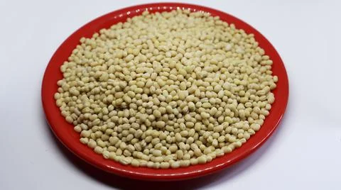 The Urad dal on the red plate are on a black background Stock Photos