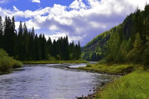 The Ural taiga river Usva flows near the steep plaster rocks of the famous to Stock Photos