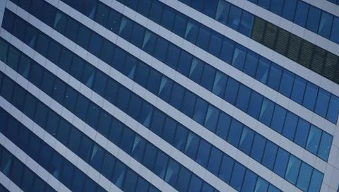 Urban abstract close up view of multiple steel and glass windows. Stock Photos