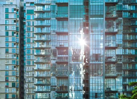 Urban abstract close up view of multiple steel and glass windows facade offic Stock Photos