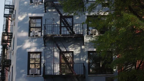 Urban apartment facade with black fire escape and windows Stock Footage 332972053