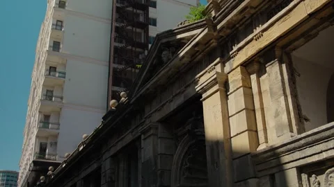 Urban Architectural Contrast Between Historic Stone Facade and Modern Building Stock Footage 338243629