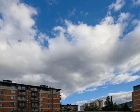 Urban architecture and dramatic cloudscape over city residential area Stock-Fotos