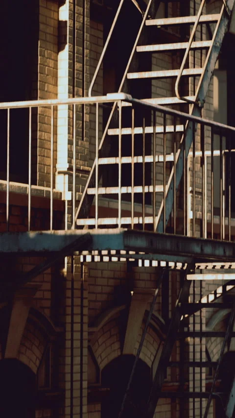 Urban architecture captures a moment of light on metal stairs Stock Footage 331697274