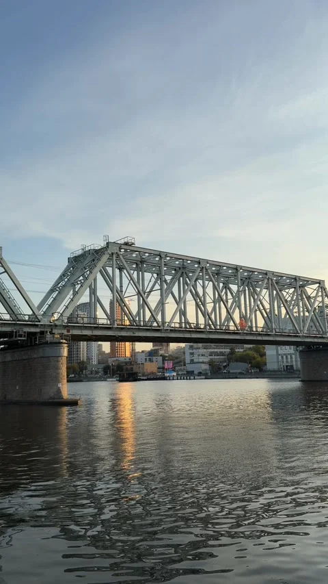 Urban bridge over river with reflection at sunset in vertical format backgrou Stock Footage 318001021