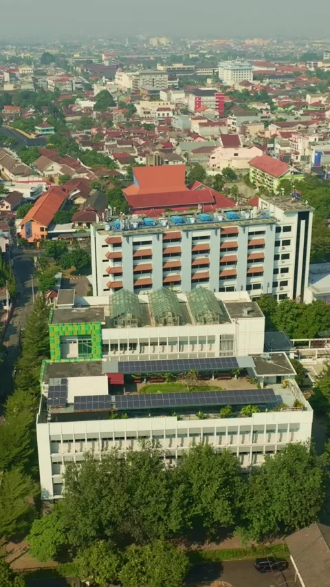 Urban building with rooftop solar panels across Yogyakarta skyline Stock Footage 342577498