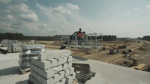 Urban building site. Construction worker descenting an industrial crane. Bridge Stock Footage 143564280