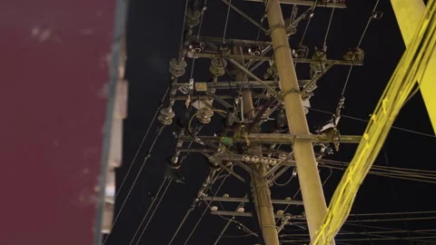 Urban cable scene. Lighting city at night with tangled electrical cables. An Stock Footage 342281430