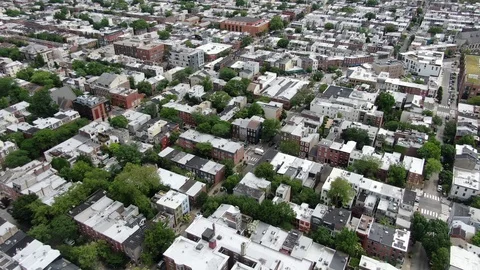 Urban city neighborhood on a cloudy day pull back Stock Footage