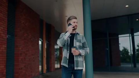 Urban Communication A Handsome Young Guy walking in Conversation, Front View, in Stock Footage 327201484