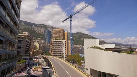 Urban Construction Scene in Monaco with Crane and Mountain Backdrop in 4K Vídeos de archivo 314772973
