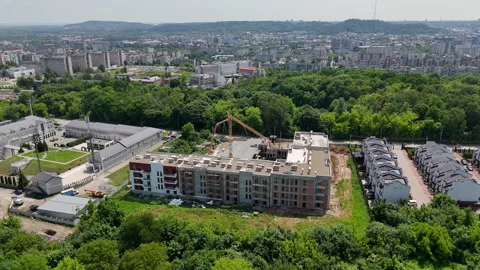 Urban Construction Site with Crane Surrounded by Residential Area, Mid-rise Stock Footage 312169431