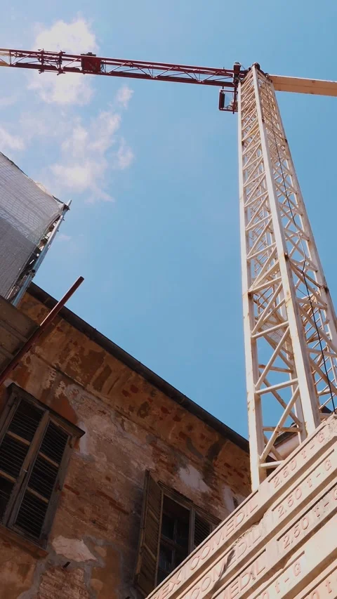 Urban Construction Site with Tower Crane Over Historic Building Video stock 314890182