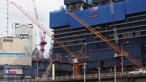 Urban construction site with tower cranes, high-rise building under construction Stock Footage 283316994