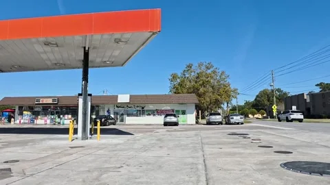 Urban corner store pan clear blue sky Stock Footage 326006223