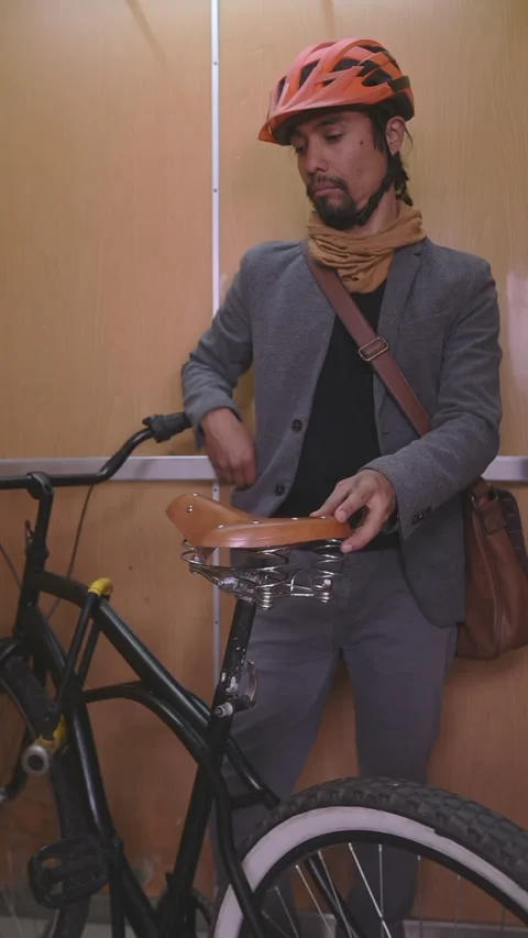 Urban cyclist using the cell phone in the elevator. Stock Footage 290160949