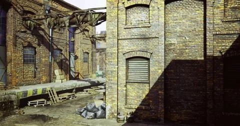 Urban decay features a weathered brick warehouse in an industrial setting Stock Illustration