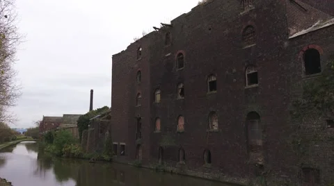 Urban decay run down abandoned brick building on canal side Stock Footage 43111868