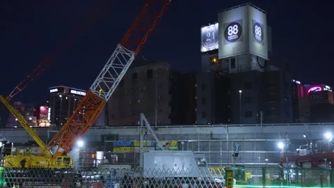 Urban Development and Construction in Osaka, Night Shot of City and Cranes, Pan Stock Footage 341488341