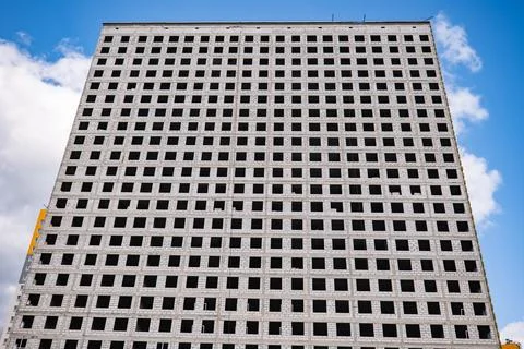 Urban development constructing large building with grid pattern windows under Stock Photos
