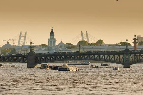 Urban ensemble at sunset, Trinity bridge, Neva River, Palace drawbridge, the cab Stock Photos