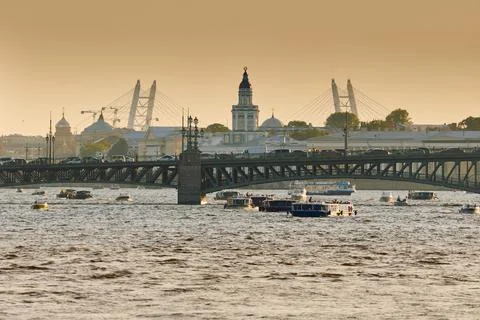 Urban ensemble at sunset, Trinity bridge, Neva River, Palace drawbridge, the cab Stock Photos