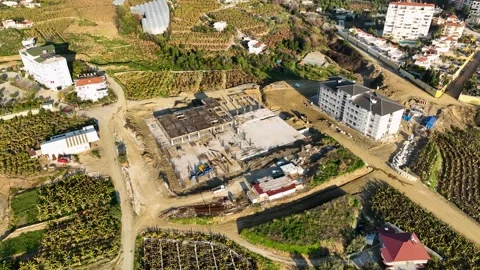 Urban Evolution: Cinematic Drone Reveals Multistory Buildings Taking Shape on Stock Footage 242610588