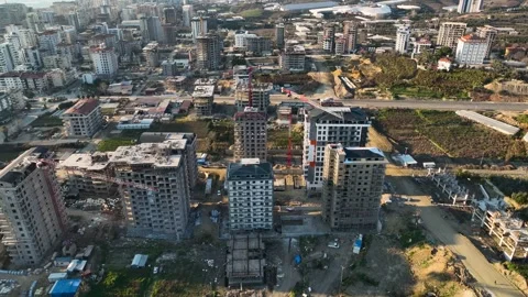 Urban Evolution: Cinematic Drone Reveals Multistory Buildings Taking Shape on Stock Footage 242611633