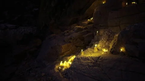 Urban explorer observes dancing fire illuminating sacred stones Stock Footage 339627188