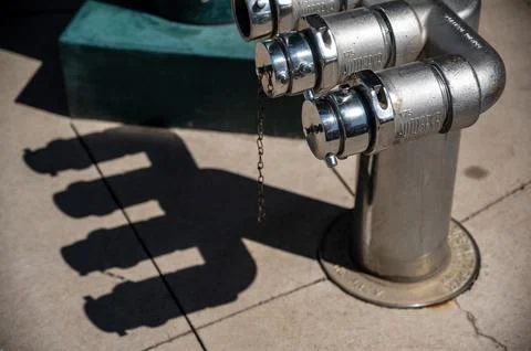 Urban fire hydrant casting shadow on cement sidewalk Stock Photos