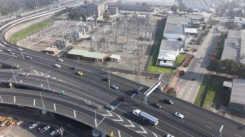 Urban freeway traffic and electrical substation aerial view 스톡 동영상 339304188