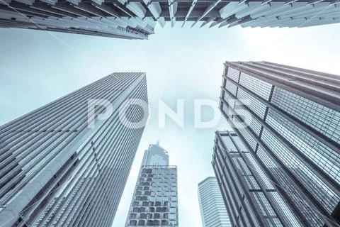 Urban Geometry, looking up to glass building. Modern architecture. Stock Photos