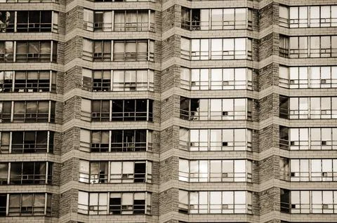 Urban geometry. Rows of large windows with various curtains, shutters, blinds Stock Photos