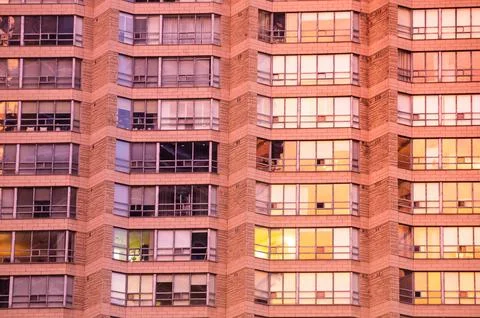 Urban geometry. Rows of large windows with various curtains, shutters, blinds Stock Photos