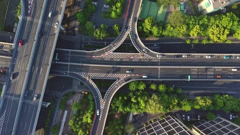 Urban highway interchange captured from above showcasing traffic flow and modern Stock Footage 313325589