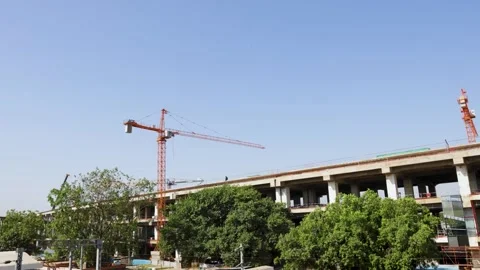 Urban infrastructure project with cranes and large building under construction Stock Footage 333639215