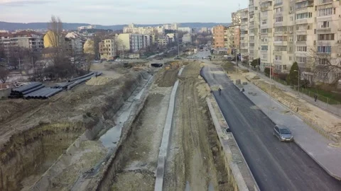 Urban infrastructure road construction progressing through city Stock Footage 346409801