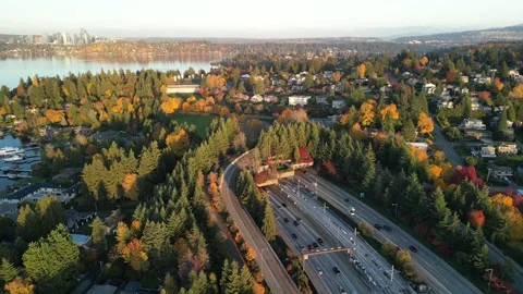 Urban Interface: Aerial View of Highway Bordering Autumn-Colored Suburb Stockbeeldmateriaal 348337006