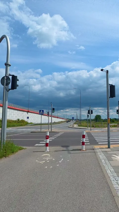Urban intersection with bollards and traffic lights on suburban road. Bicyc.. Stock Footage 341972692