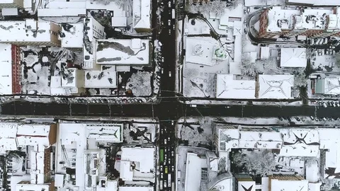 Urban landscape. A busy city intersection. View vertically down to the snow-cove Stock Footage 75885366