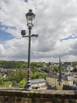 Urban landscape with modern elements, clouds in the sky and a historic lantern, 写真素材