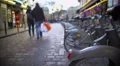 Urban life, bicycles for rent, people walking down the street, enjoying weekend 4k or 4k+ Resolution