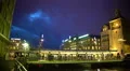 Urban life, passengers entering modern tram, brightly illuminated city center 4k or 4k+ Resolution