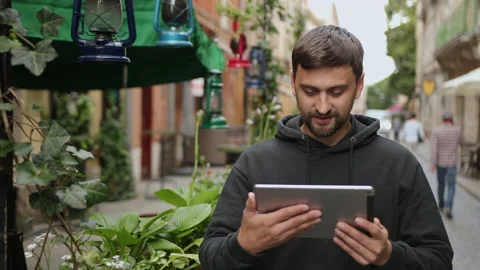 Urban man using tablet computer outside app on 5g wireless device. Casual male Stock Footage 138291289