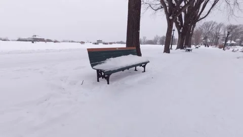 Urban park bench after snowfall in winter 스톡 동영상 323972679
