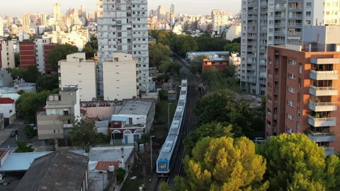 Urban Passenger Train Moving Between Apartment Buildings in Buenos Aires Stock-Footage 331897287